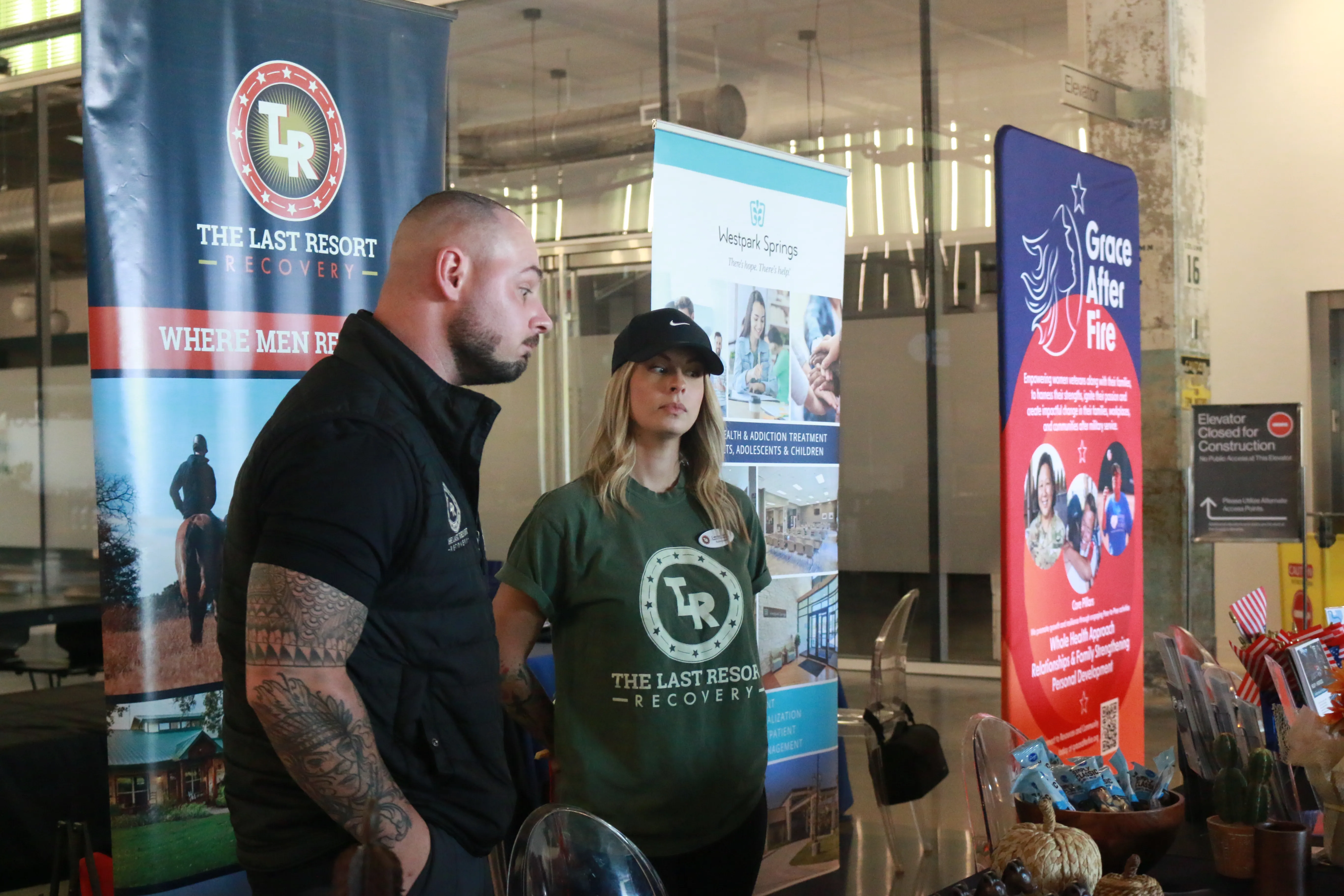 Recovery organization booth representatives at a community event