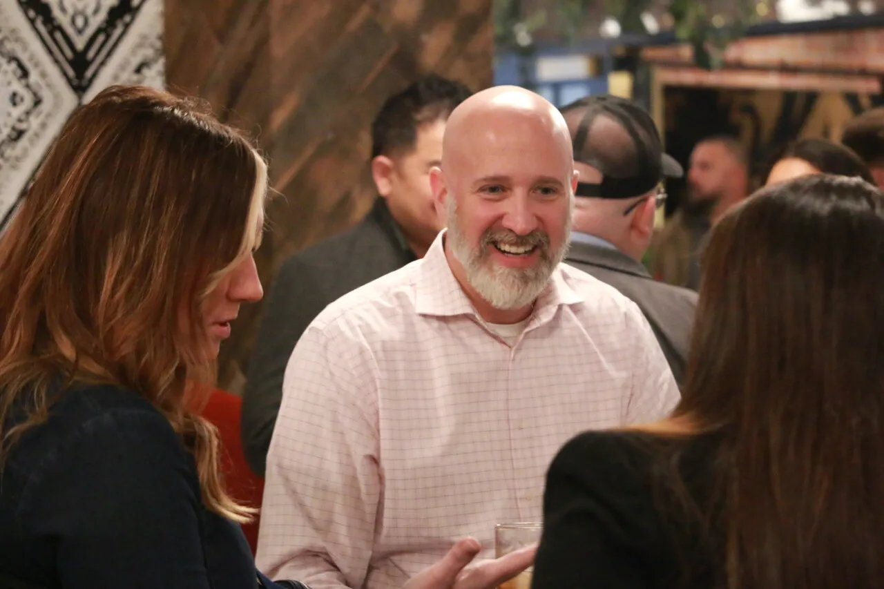 Guests networking at a holiday community mixer event