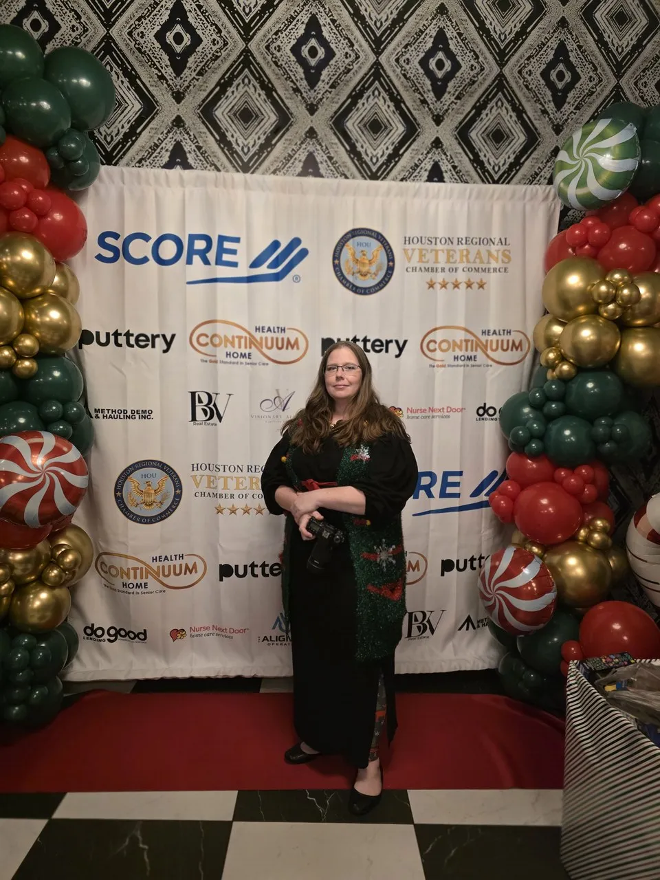 Event sponsor backdrop at a holiday community mixer