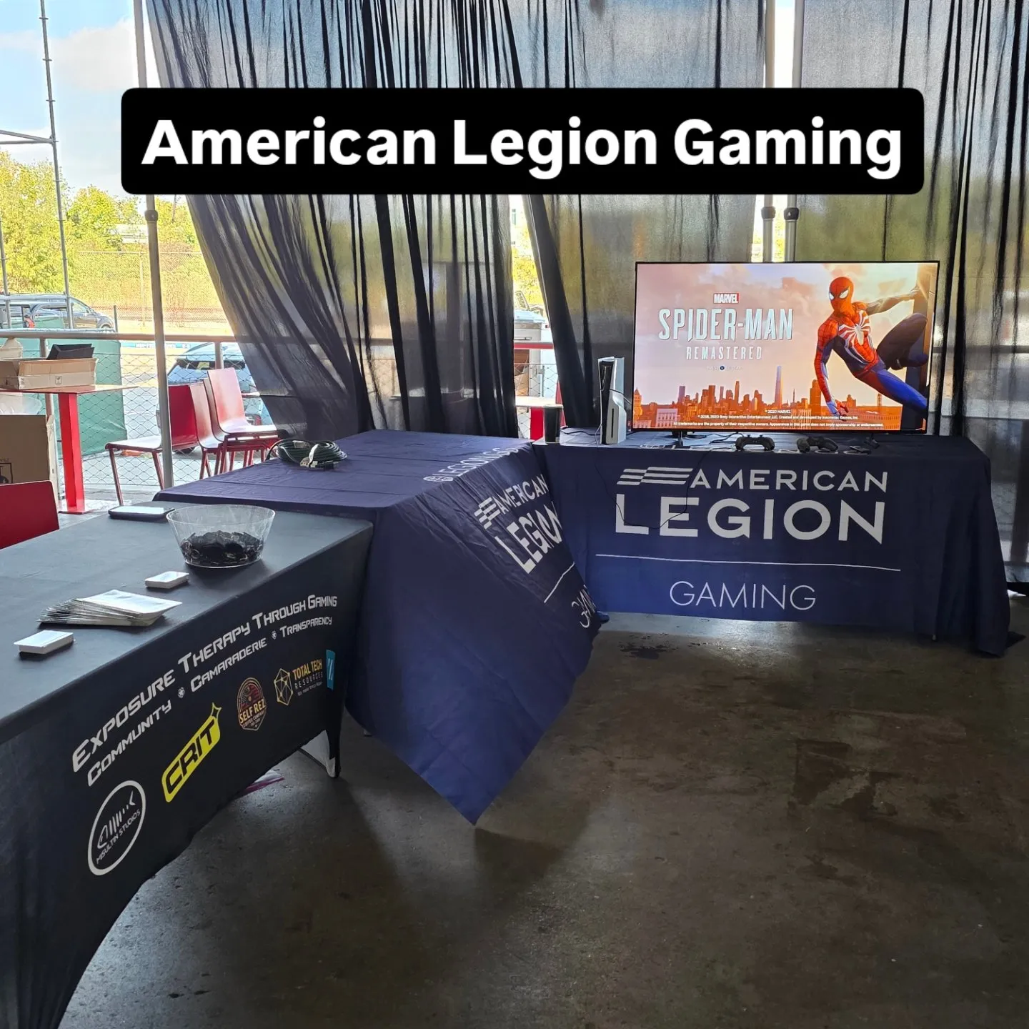 American Legion Gaming booth setup with branded tables and screen display