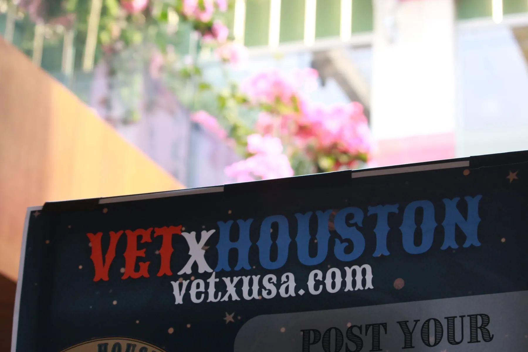 Veteran event signage detail with flowers in the background