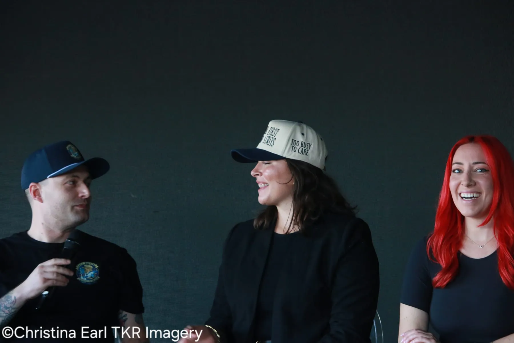 Panel guests laughing during a community business event