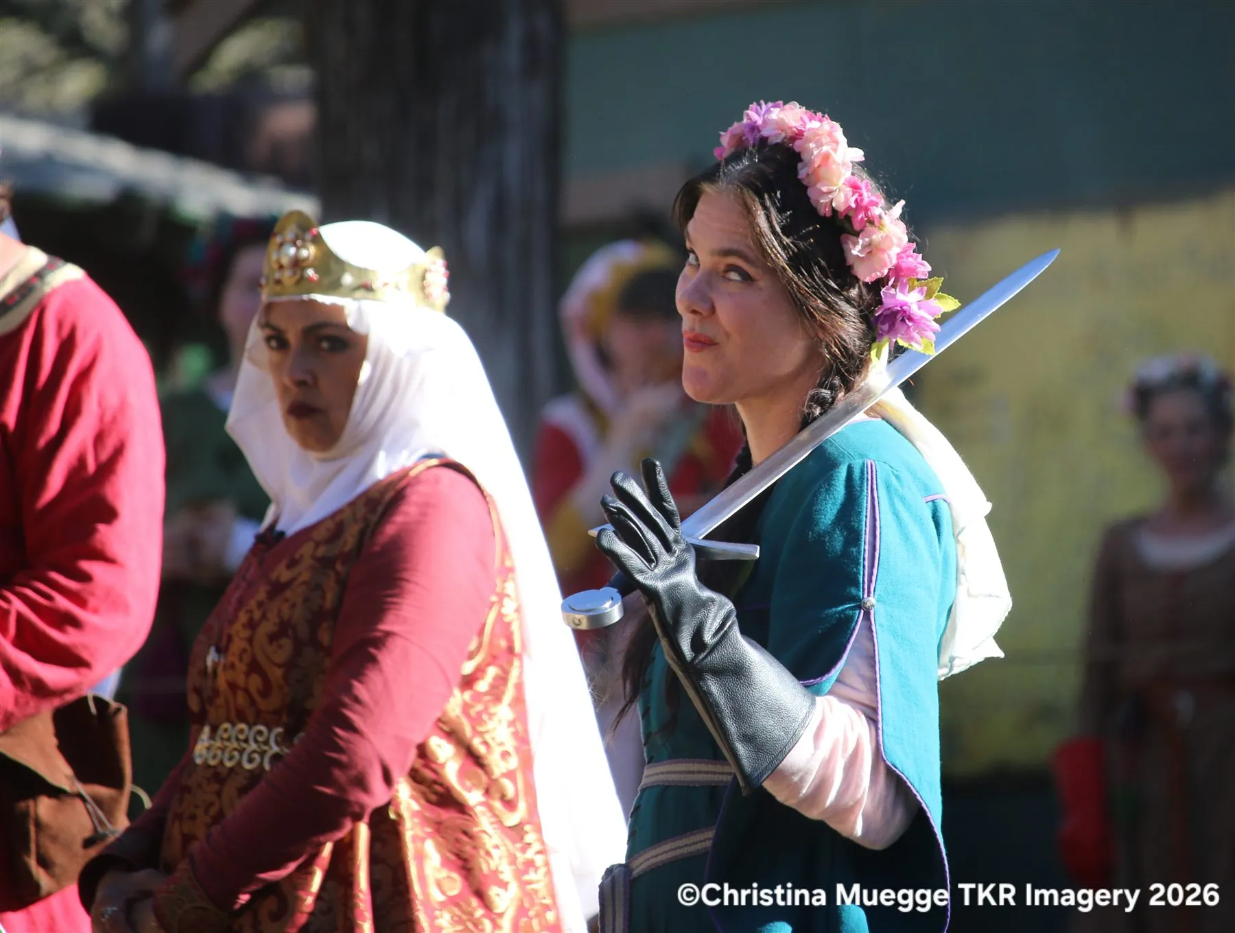 Renaissance festival performer holding a sword during a live event