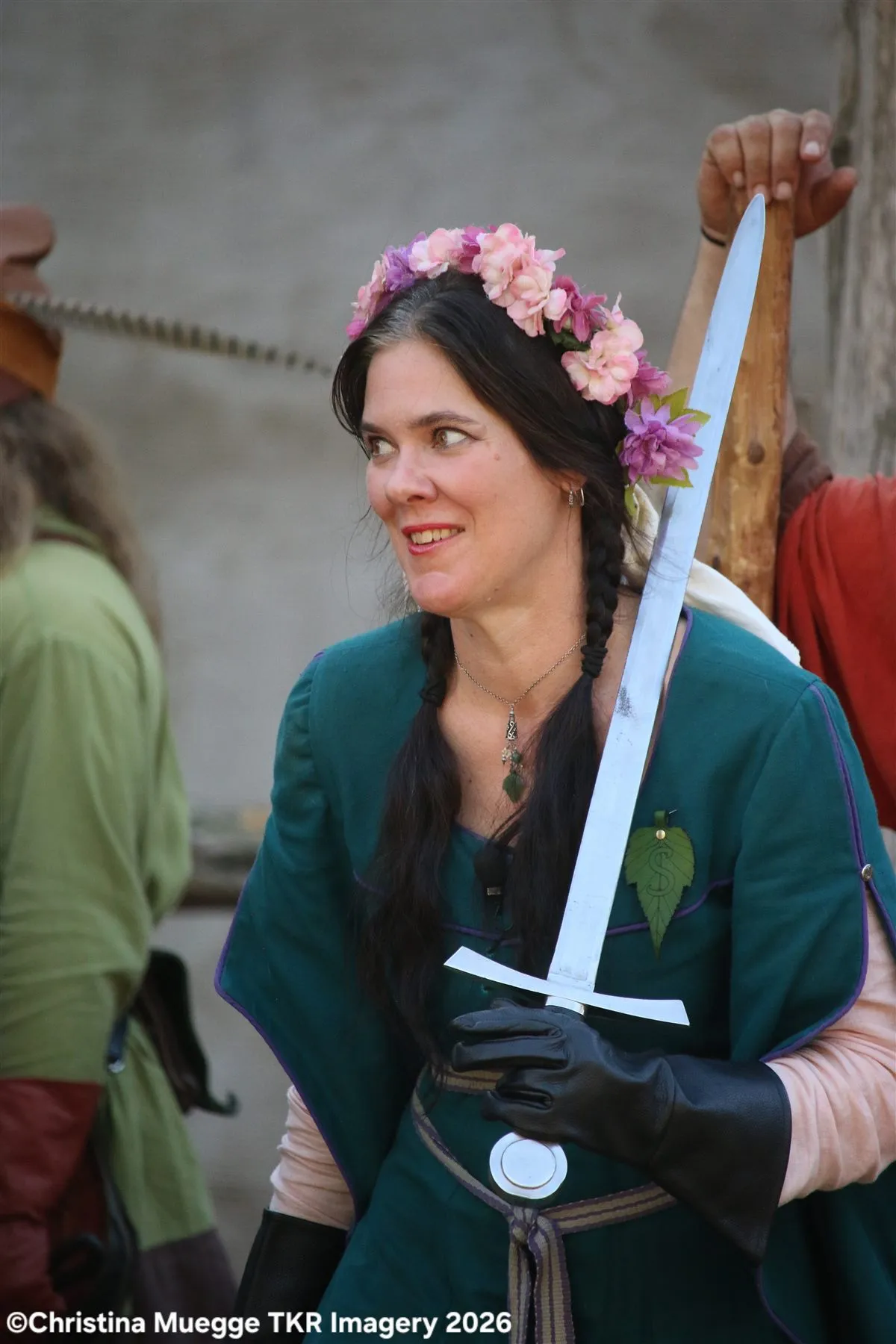 Renaissance festival performers peeking around a castle wall