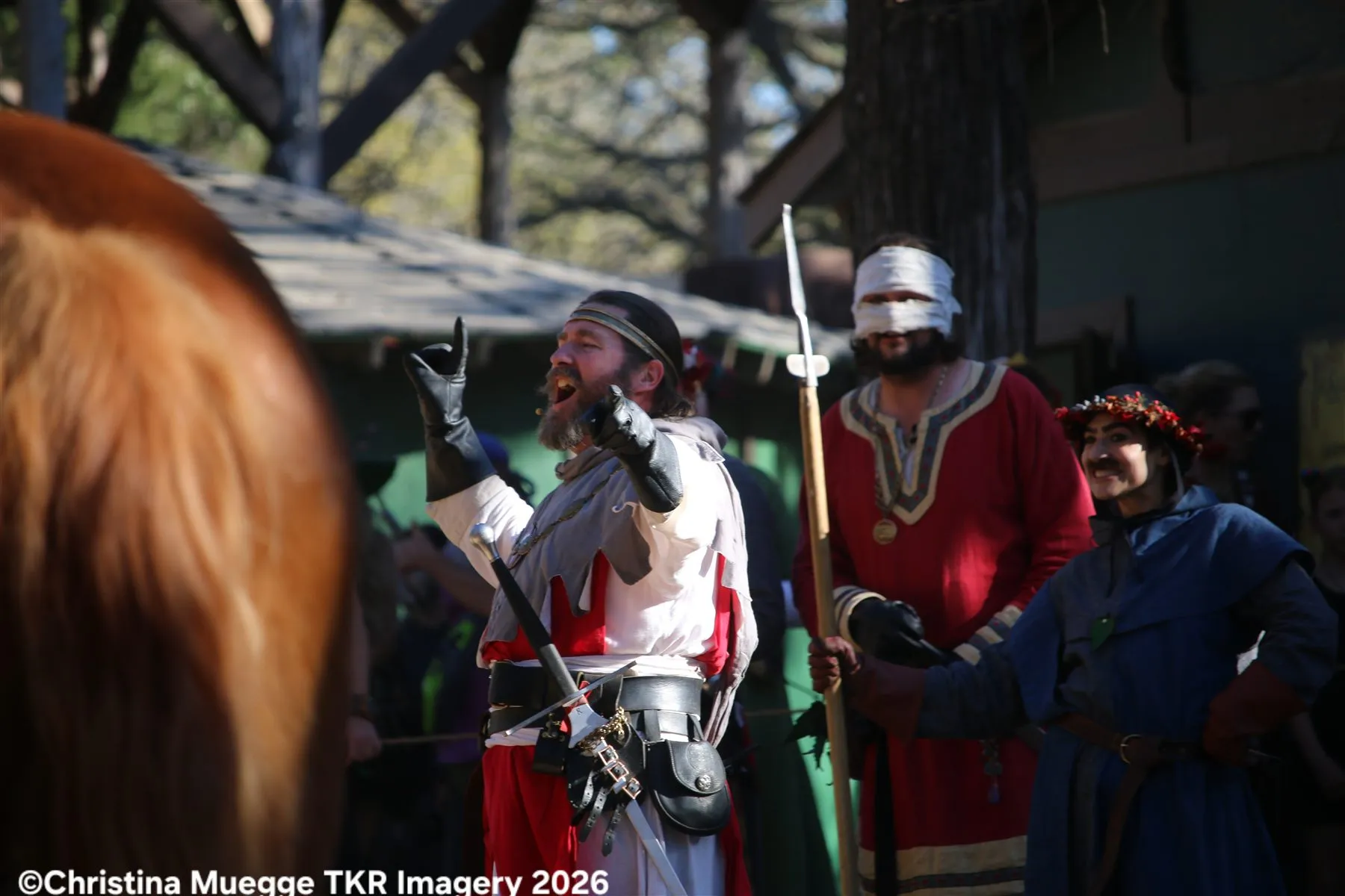 Renaissance festival court performers acting in a comedy scene