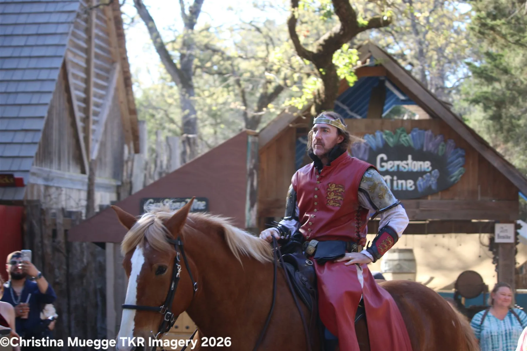 Renaissance festival performer riding a horse during an outdoor live show