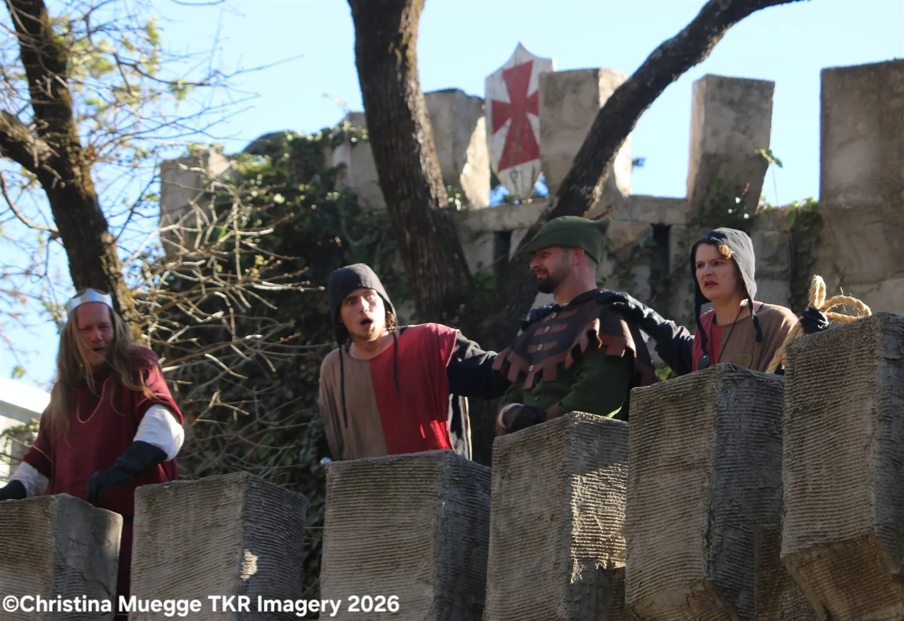 Renaissance festival performer holding a spear during a live scene