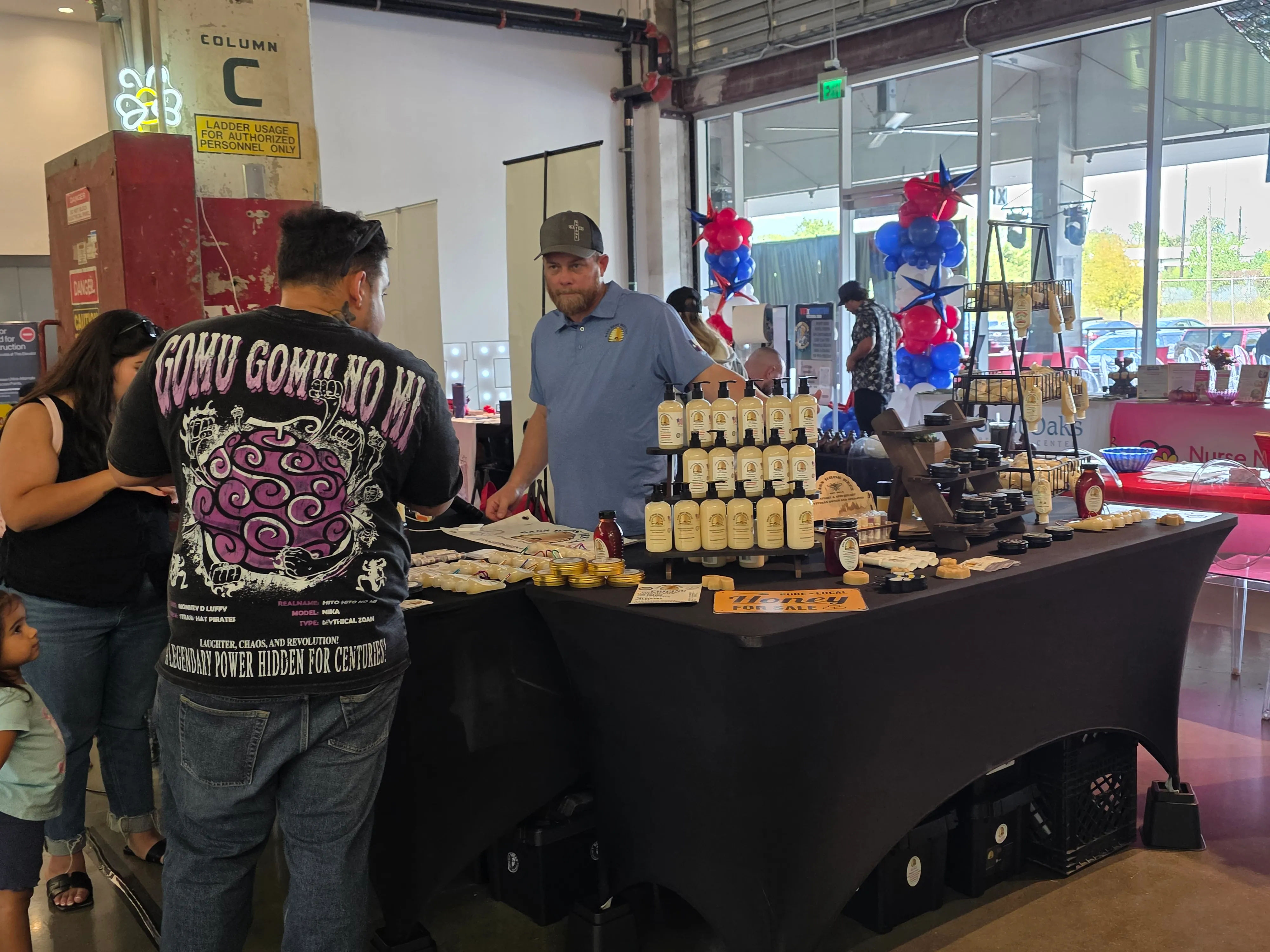 Guests visiting a vendor booth during a community event